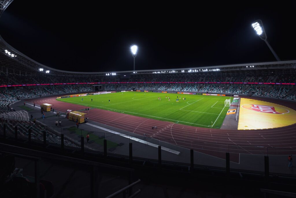 A floodlit football stadium during an evening match