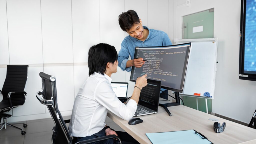 Kick the Tyres on a Public-Record API Before Writing Any Code Engineers reviewing code on a monitor: Kick the Tyres on a Public-Record API Before Writing Any Code