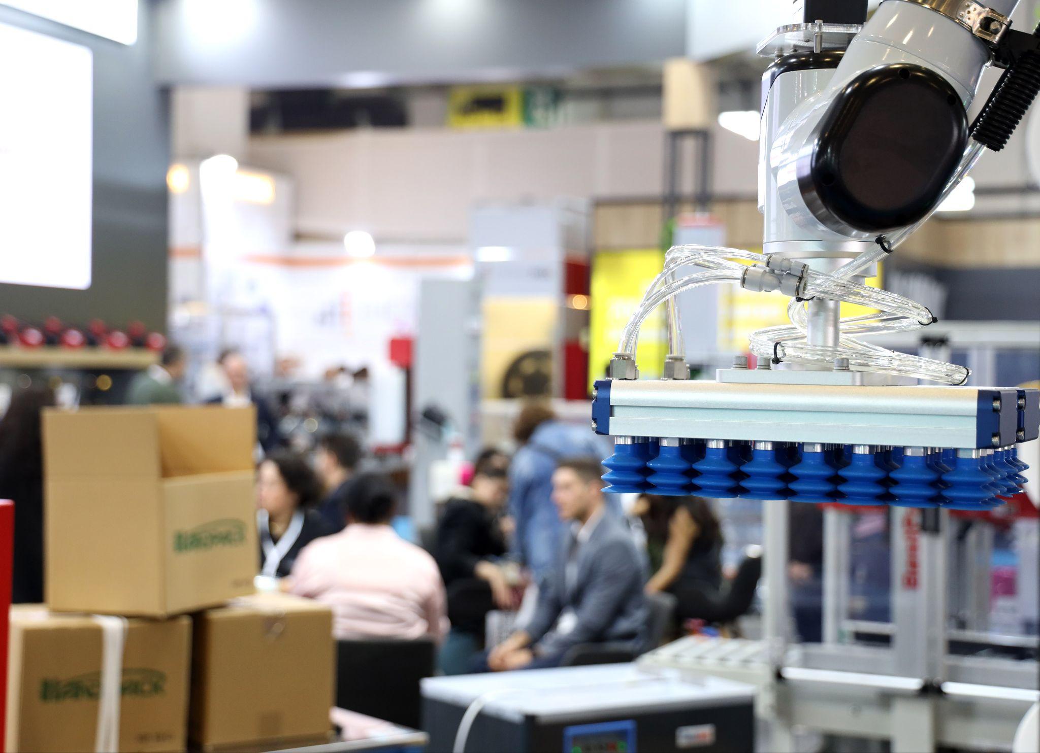 The 31st Eurasia Packaging Istanbul opens its doors on 13 October 2026: a robotic vacuum gripper lifting cartons on an exhibitor stand at Eurasia Packaging Istanbul